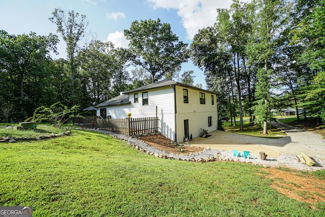 view of home's exterior featuring a yard and a patio area