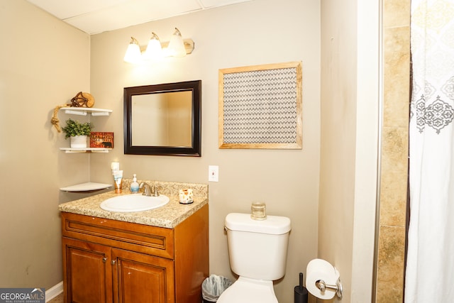 bathroom featuring toilet and vanity