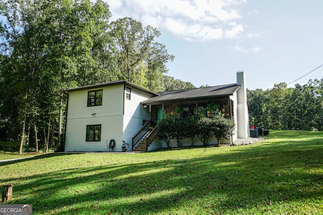 view of home's exterior featuring central air condition unit and a lawn