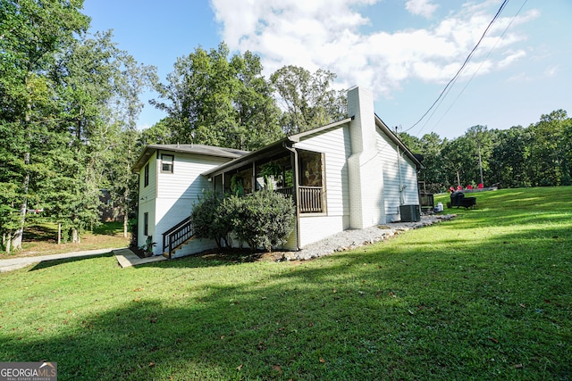 view of home's exterior featuring a lawn and cooling unit