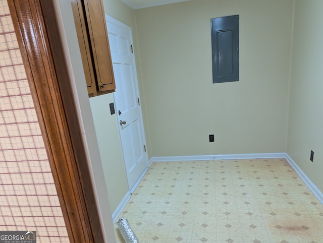 laundry room featuring electric panel, cabinets, and crown molding