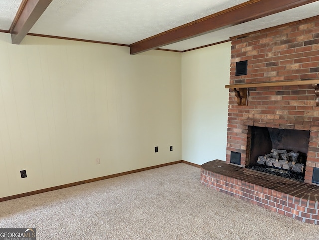 unfurnished living room featuring a textured ceiling, carpet flooring, a brick fireplace, and beam ceiling