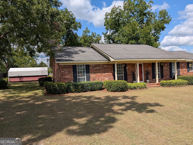 single story home with covered porch and a front yard