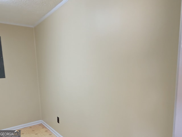 interior details with ornamental molding and a textured ceiling