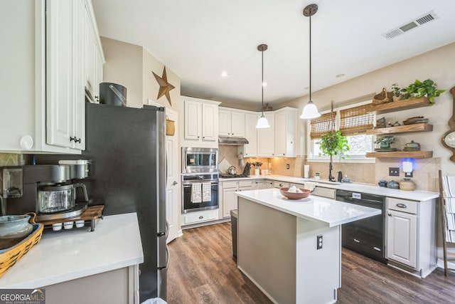 kitchen with white cabinets, decorative light fixtures, stainless steel appliances, dark hardwood / wood-style floors, and a kitchen island