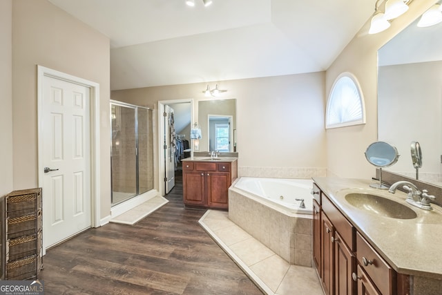 bathroom with hardwood / wood-style floors, separate shower and tub, and vanity