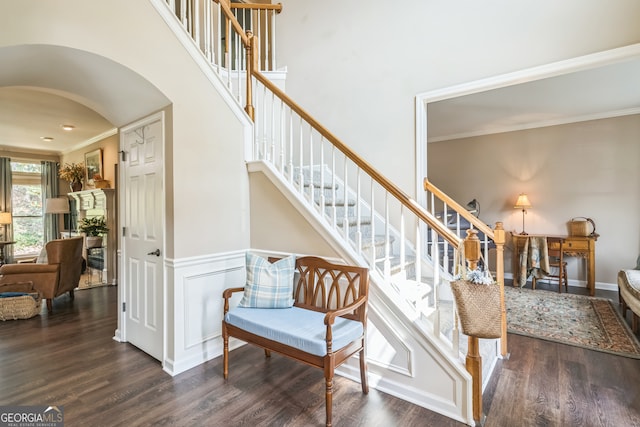 stairs featuring crown molding and wood-type flooring