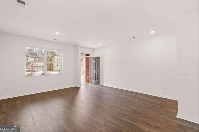 empty room featuring dark hardwood / wood-style flooring