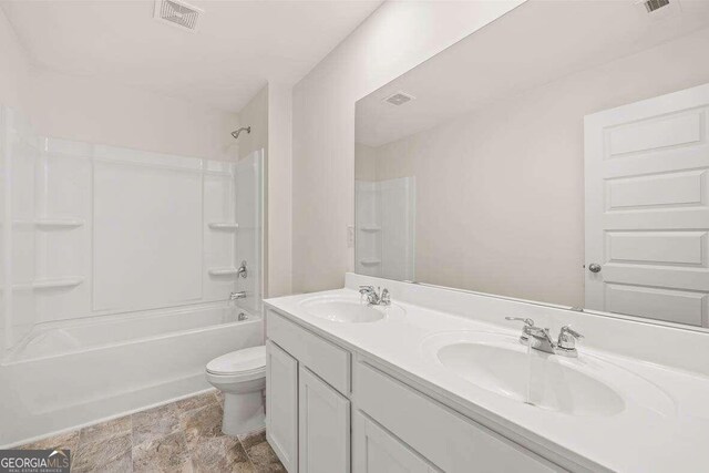 full bathroom featuring vanity, tub / shower combination, and toilet