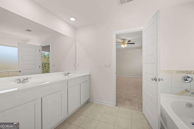 bathroom featuring vanity, tile patterned floors, a tub, and ceiling fan