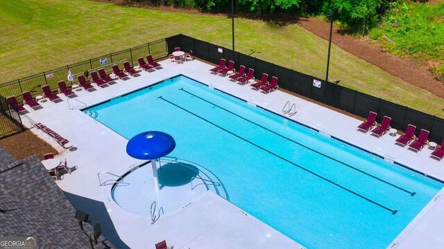 view of pool featuring a lawn and a patio area