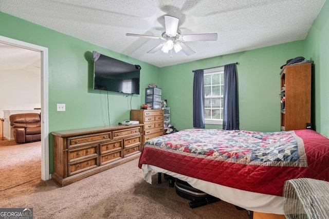 bedroom featuring a textured ceiling, ceiling fan, and carpet