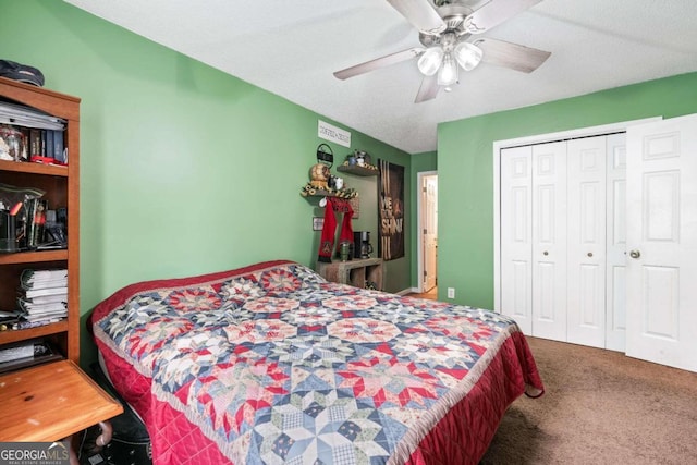 carpeted bedroom with a textured ceiling, ceiling fan, and a closet