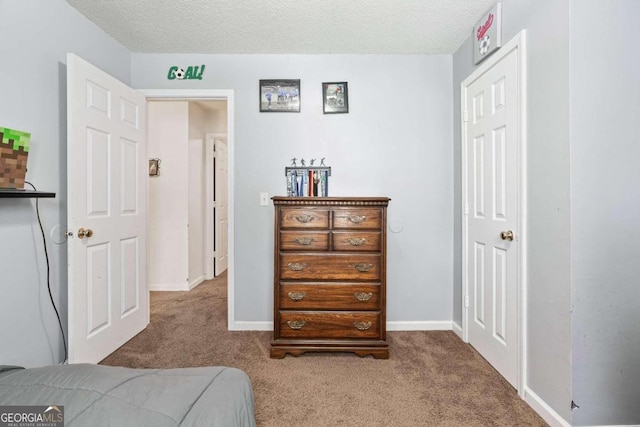 carpeted bedroom featuring a textured ceiling