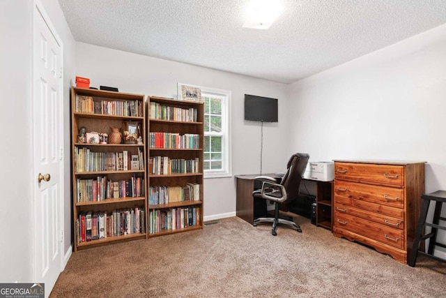 carpeted office featuring a textured ceiling