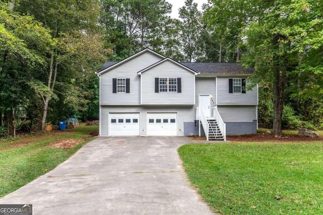 bi-level home featuring a garage and a front lawn