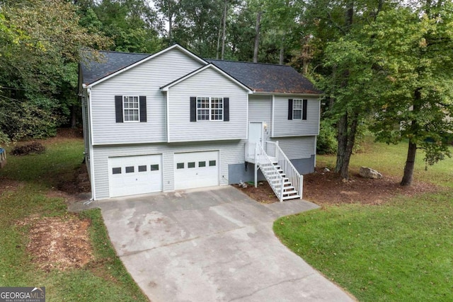 bi-level home featuring a garage and a front lawn