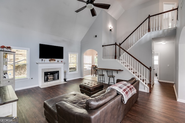 living room with high vaulted ceiling, ceiling fan, and dark hardwood / wood-style flooring