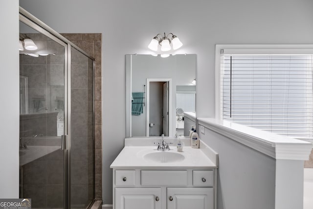 bathroom featuring vanity and a shower with door