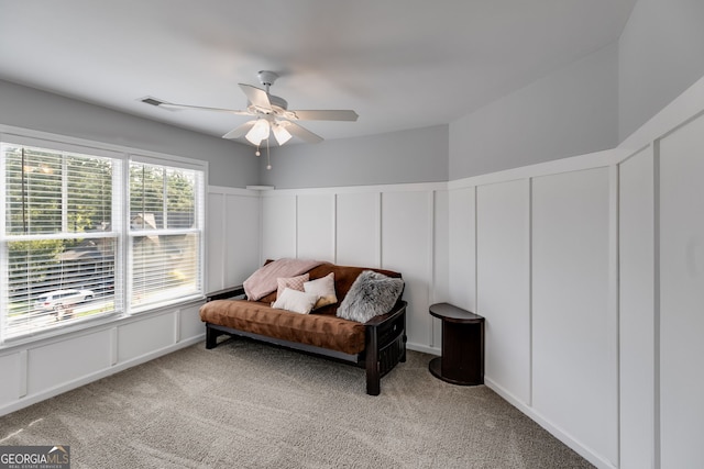 sitting room featuring ceiling fan and light carpet