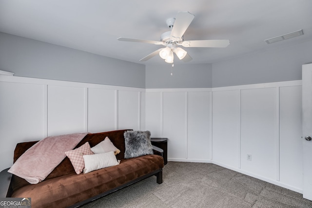 living room with ceiling fan and light colored carpet