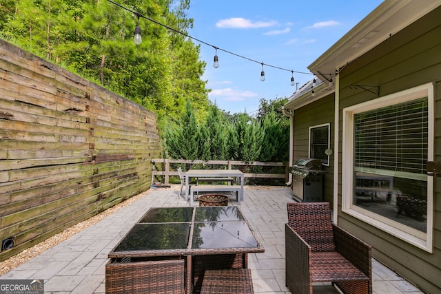 view of patio / terrace featuring a grill and an outdoor fire pit