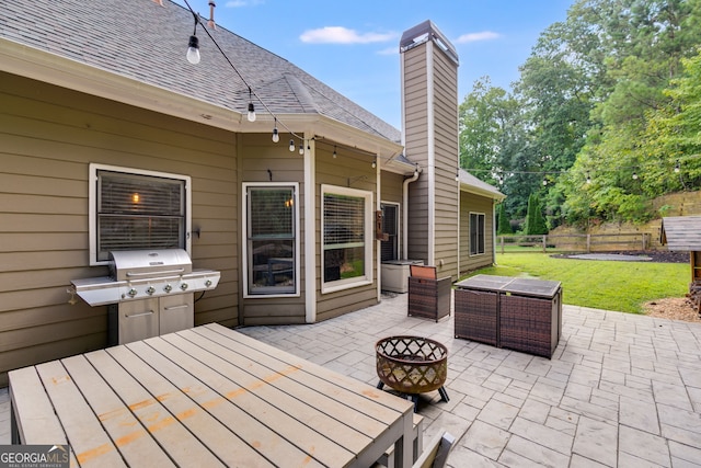 view of patio / terrace with area for grilling and an outdoor fire pit