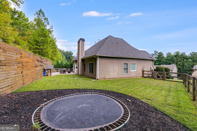 view of yard featuring a trampoline and a patio area