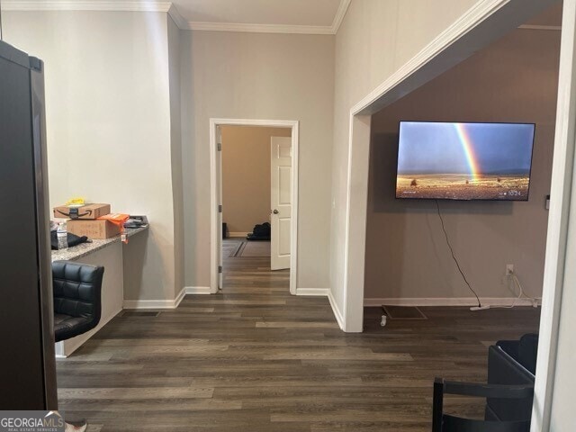 hallway with ornamental molding and dark hardwood / wood-style floors