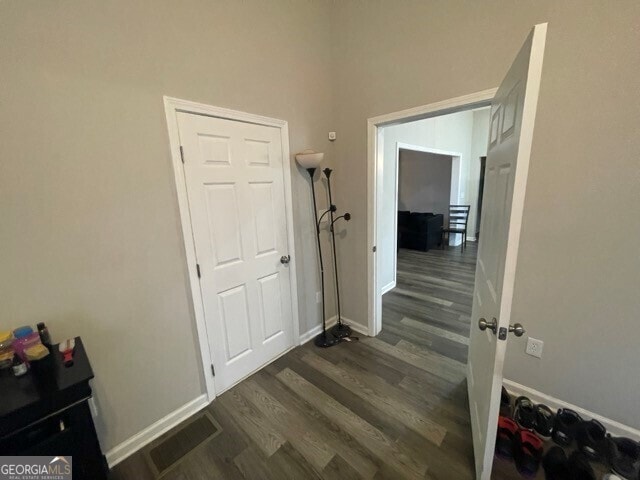 hall featuring dark wood-type flooring