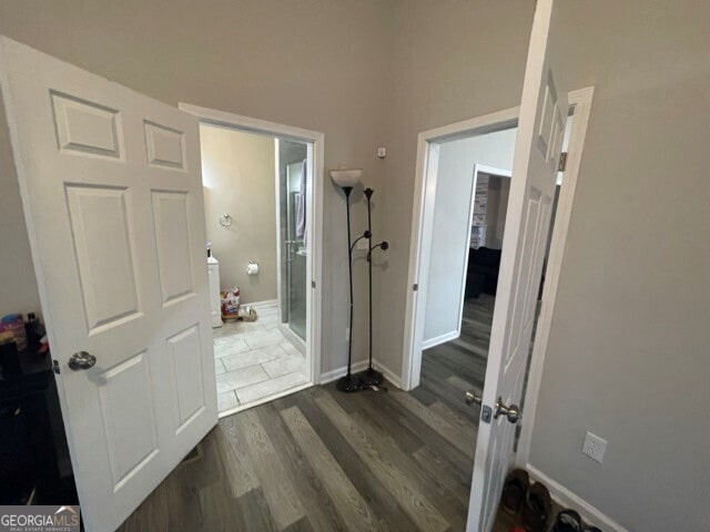 hallway featuring dark hardwood / wood-style flooring