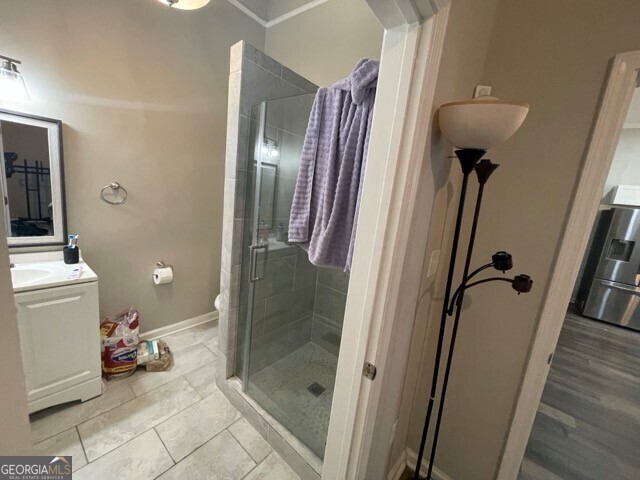 bathroom with washer / clothes dryer, vanity, toilet, and walk in shower