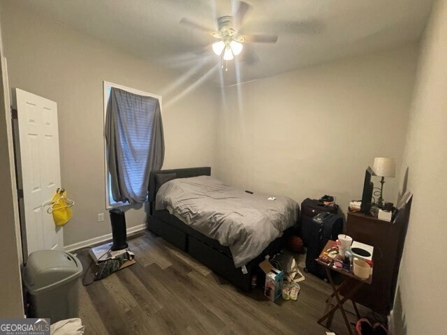 bedroom featuring ceiling fan and dark hardwood / wood-style floors