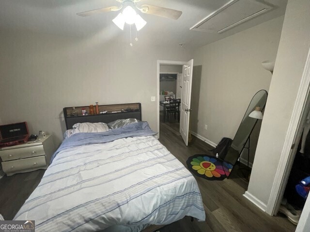 bedroom with dark hardwood / wood-style flooring and ceiling fan