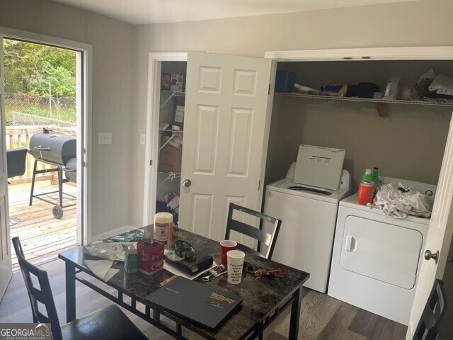 dining space featuring independent washer and dryer and dark hardwood / wood-style flooring