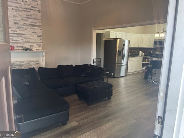 living room featuring dark wood-type flooring and a fireplace