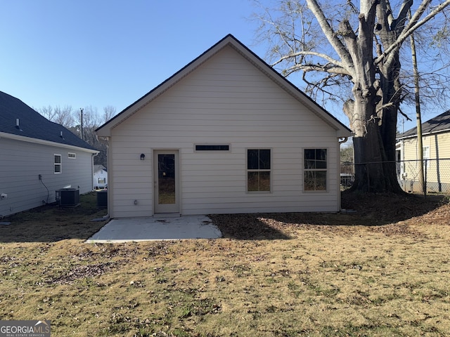 rear view of property featuring a patio area, central AC, and fence