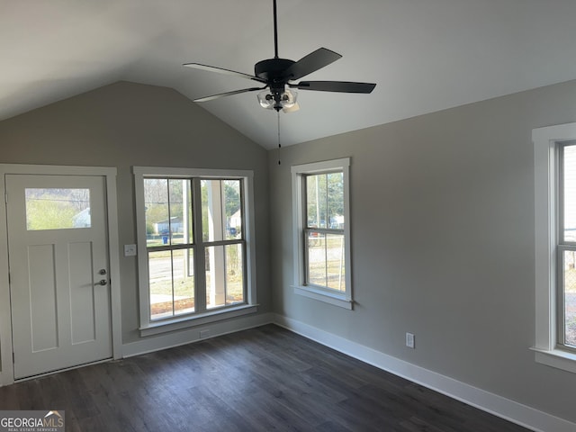 foyer entrance featuring dark wood finished floors, vaulted ceiling, baseboards, and ceiling fan