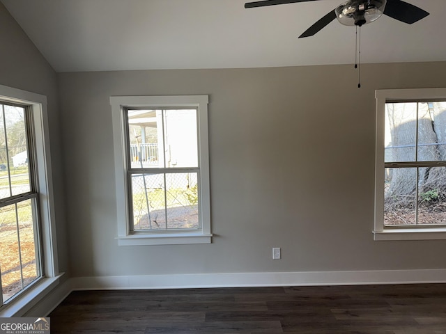 unfurnished room featuring a wealth of natural light, lofted ceiling, and dark wood-style floors