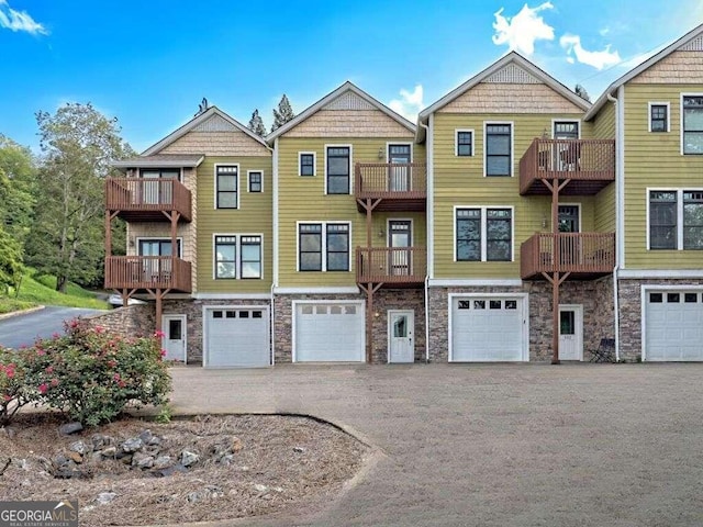 1401 Lakeside Rd, Hiawassee, GA 30546 - view of property featuring stone siding, driveway, and a garage