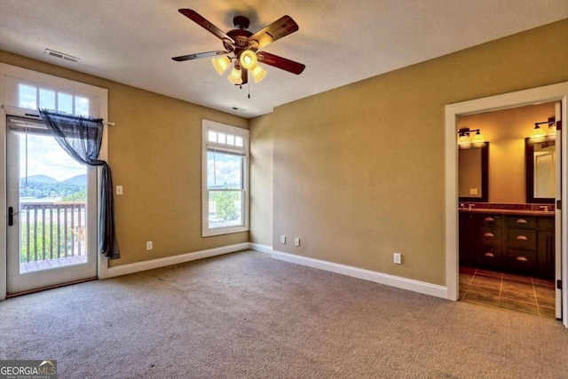 interior space featuring ceiling fan and carpet