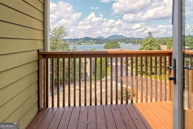 deck with a water and mountain view