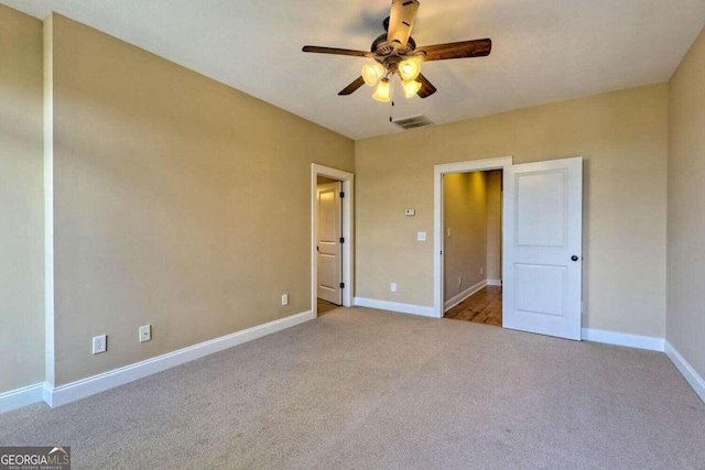 unfurnished bedroom with ceiling fan and light carpet