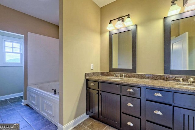 bathroom featuring vanity, tile patterned flooring, and a washtub