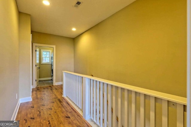 corridor with hardwood / wood-style flooring