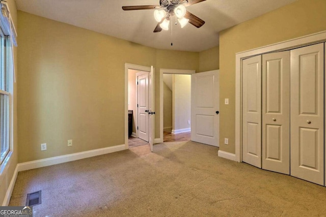 unfurnished bedroom with a closet, ceiling fan, and light colored carpet