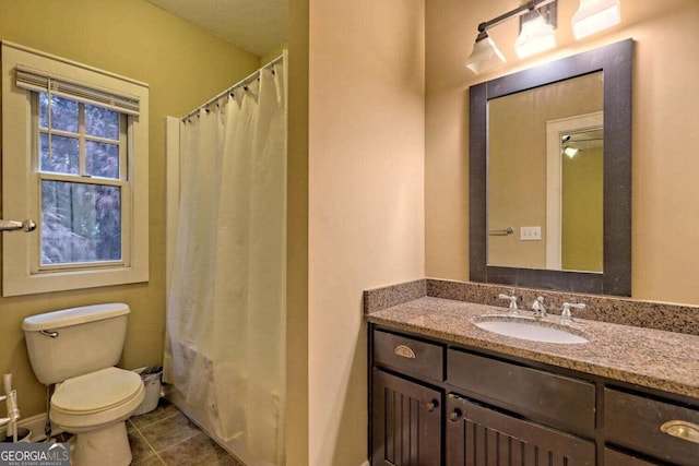 bathroom with vanity, toilet, and tile patterned flooring