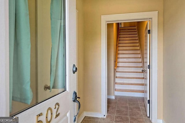 hallway with dark tile patterned flooring