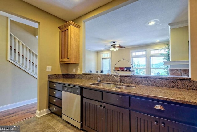 kitchen featuring dishwasher, hardwood / wood-style flooring, sink, ceiling fan, and a textured ceiling