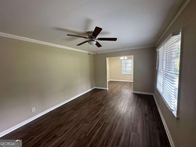 empty room featuring ornamental molding, ceiling fan, and dark hardwood / wood-style floors